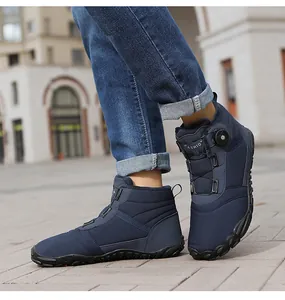 Close-up view of blue high-top winter snow boots featuring a rotary buckle closure