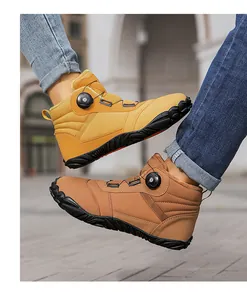 Detailed view of yellow and brown outdoor winter snow boots with rotating buckle system
