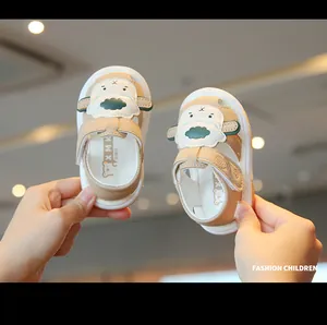 Close-up view of cute beige cartoon baby sandals featuring soft non-slip rubber soles