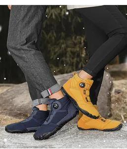 Close-up of couples wearing warm high-top snow boots with dial lacing system in snow