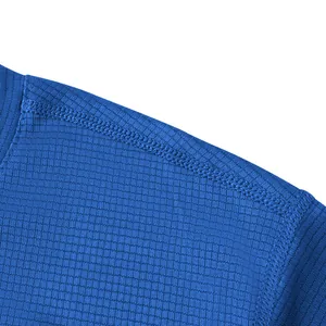 Close-up of premium blue mesh ice silk t-shirt fabric showing detailed double stitching