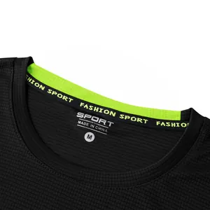 Detailed macro view of black moisture-wicking waffle fabric neckline with size M label