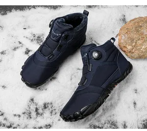 Close-up of navy blue winter snow boots with warm fur lining and dial lacing system