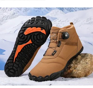Detailed view of brown winter boots featuring a rotary buckle and textured rubber sole.