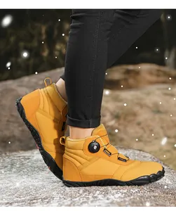 Close-up of mustard yellow high-top snow boots with rotary lacing system and fleece lining