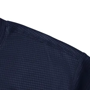 Close-up of navy blue quick-dry athletic shirt showing textured fabric and stitching.