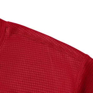 Close-up view of red quick-dry sports t-shirt fabric texture and shoulder stitching
