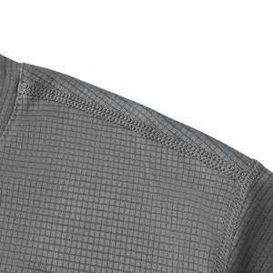 Macro detail of breathable waffle fabric and reinforced shoulder seam on grey t-shirt