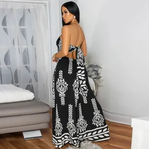 Back view of elegant black and white patterned tube top wide-leg jumpsuit with tie-back.