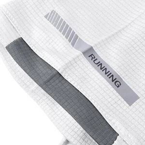 Close-up detail of white quick-dry running shirt with reflective RUNNING strip