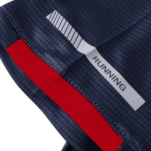 Macro detail of quick-dry breathable fabric and reflective running strip on navy sports t-shirt.