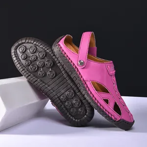 Detailed view of bright pink hollow-out outdoor sandals with textured non-slip sole.