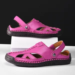 Side view detail of vibrant magenta closed-toe hollow-out sandals with durable rubber sole.