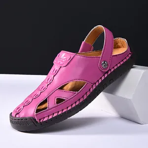 Detailed macro view of purple hollow-out leather sandals with adjustable heel strap