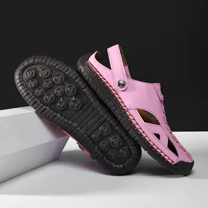Bright pink closed-toe leather sandals with hollow-out design and anti-slip rubber sole detail