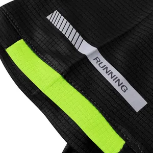 Macro view of quick-dry running shirt featuring a reflective strip and neon green stripe
