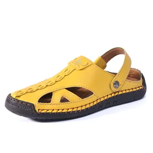 Bright yellow closed-toe leather sandals with hollow cutouts and a thick black rubber sole.
