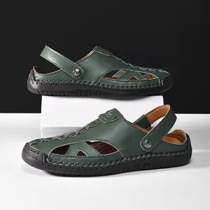 Detail of green closed-toe leather sandals with hollow cutouts for summer beach wear.