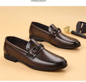 Side view of elegant brown leather loafers with metal buckle and premium cowhide texture