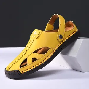 Close-up detail of yellow closed-toe outdoor sandals featuring hollow design and stitching