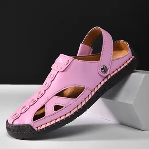 Macro detail of pink hollow leather sandals featuring adjustable strap and rubber sole