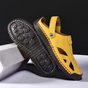 Close-up detail of yellow leather hollow-out sandals showing hand-stitched seams and sole