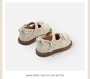 Detail showing cream toddler Mary Janes with a cute bunny face and ruffled fabric trim.