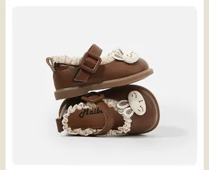 Detailed view of brown Mary Jane baby shoes with cute bunny and lace trim.