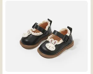 Detailed view of black baby girl princess shoes with cute rabbit patch and lace trim