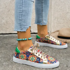 Detailed view of women's colorful printed canvas sneakers with golden accents.