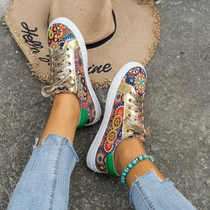 Detail view of colorful patterned canvas sneakers with gold metallic accents.