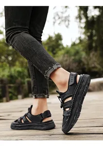 Detailed view of men's black breathable sandals with handmade stitching for outdoor wear.