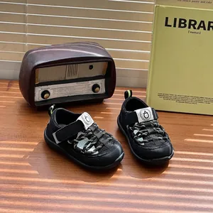 Close-up of black breathable baby sandals with protective toe cap and hook-and-loop closure