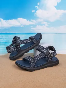 Detailed view of durable boys beach sandals with adjustable straps on sand