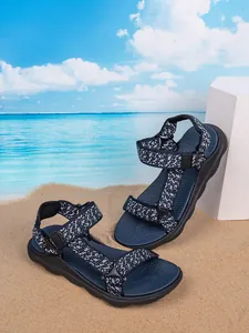 Stylish navy blue boys outdoor sandals with non-slip soft sole on beach sand background