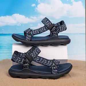 Detailed view of children's outdoor beach sandals with patterned straps on sand background