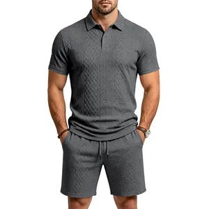 Detailed macro texture of charcoal grey men's heavy jacquard polo shirt and matching shorts set.