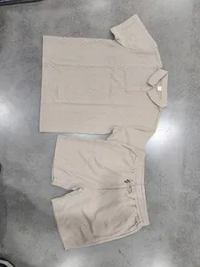 Detailed view of men's beige heavy jacquard polo shirt and shorts set layout