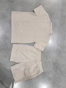 Detailed flat lay of men's beige heavy jacquard polo shirt and shorts summer set