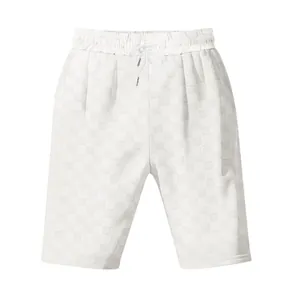 Detail view of white men's casual relaxed shorts with jacquard checkerboard pattern