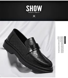 Detail view of a black hollowed leather loafer with a chunky sole and buckle
