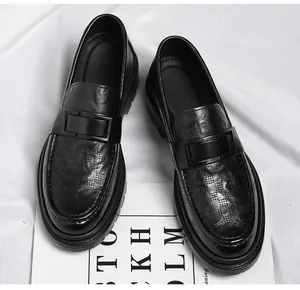 Detailed view of black hollow breathable slip-on loafers for men with decorative buckle.