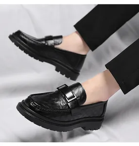 Detail of black breathable leather loafers with buckle and perforated design