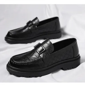 Close-up of black men's leather loafers with breathable perforated patterns and buckle.