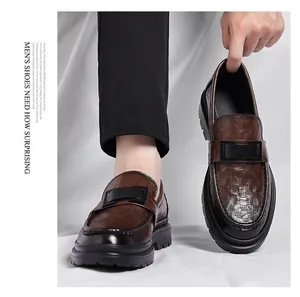 Close-up of men's brown hollow leather loafers featuring breathable perforated design