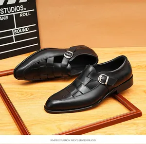Detailed macro view of black leather woven monk strap sandals showing buckle detail.