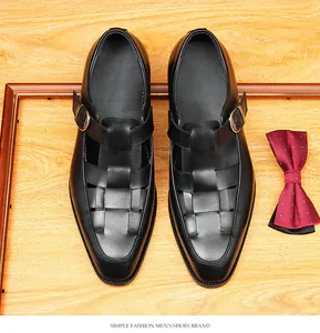 Top-down detail of black woven leather sandals with buckle closure on a wooden background.