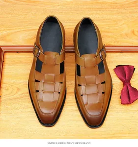 Top view of men's woven leather sandals with buckle detail on wood background
