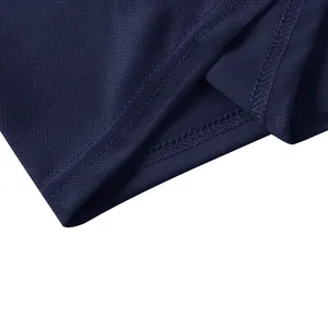 Close-up detail of durable double-stitched hem and breathable fabric on navy polo shirt
