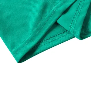 Close-up of the stitching and breathable mesh fabric of the green polo shirt